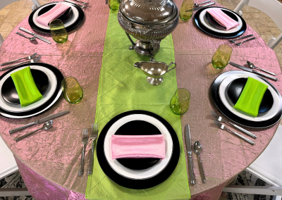 Full tablescape of Elphaba and Glinda Wicked themed design in evil emerald green and popular pink