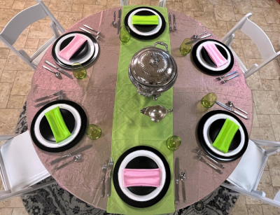 Overhead view of Elphaba and Glinda Wicked themed tabletop design in evil emerald green and popular pink